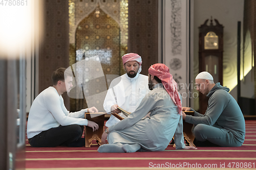 Image of muslim people in mosque reading quran together