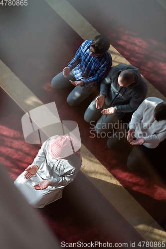 Image of group of muslim people praying namaz in mosque.