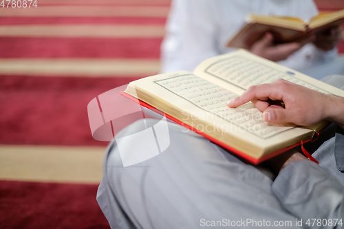 Image of two muslim people in mosque reading quran together concept of islamic education