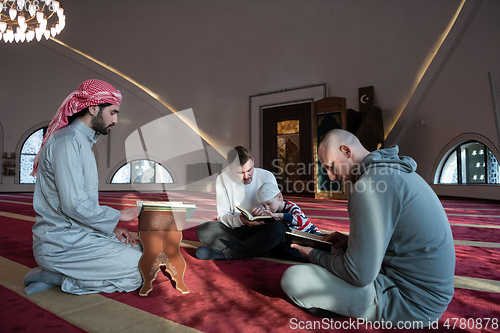 Image of muslim people in mosque reading quran together