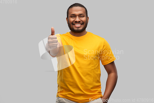 Image of smiling african american man showing thumbs up