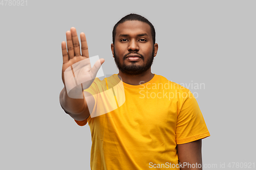 Image of african american man showing stop gesture