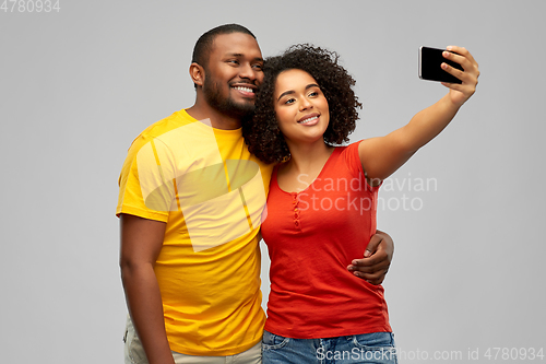 Image of african american couple takes selfie by smartphone