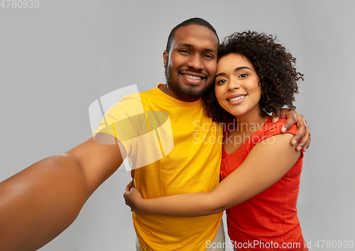 Image of happy smiling african american couple takes selfie