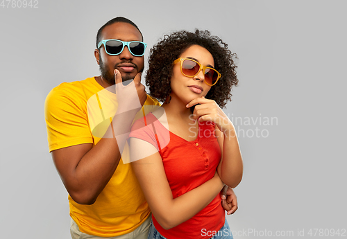 Image of african couple in sunglasses thinking