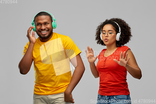 Image of african american couple with headphones dancing