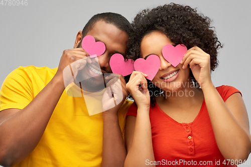 Image of happy african american couple with hearts
