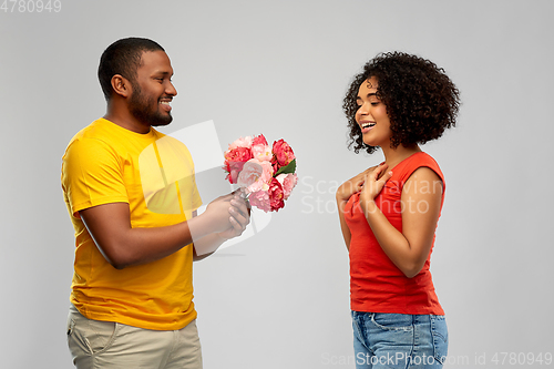 Image of happy african american couple with flowers