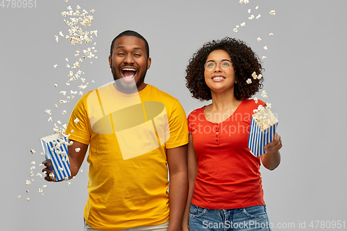 Image of happy african american couple with popcorn