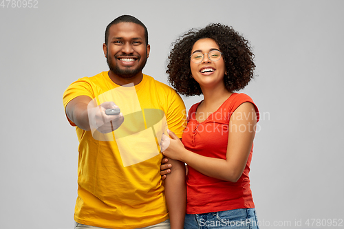 Image of african american couple with tv remote control