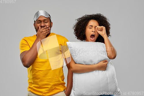 Image of african couple with eye sleeping mask and pillow