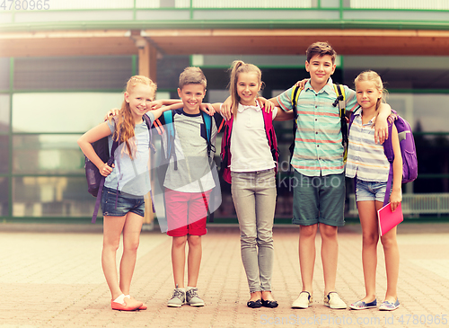 Image of group of happy elementary school students hugging