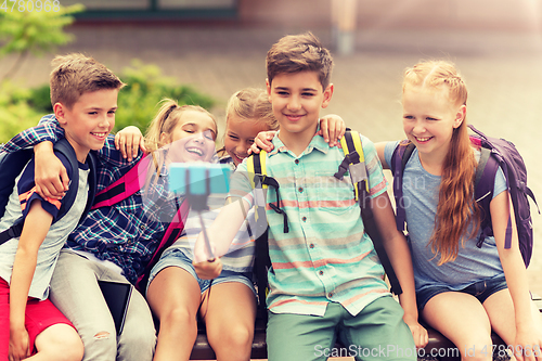 Image of happy elementary school students taking selfie