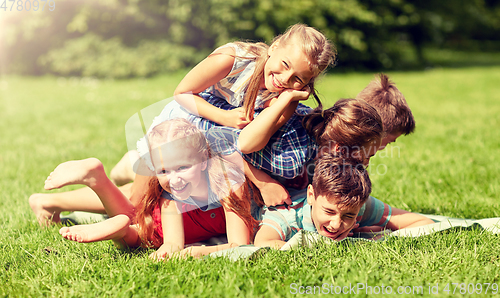 Image of happy kids playing and having fun in summer park