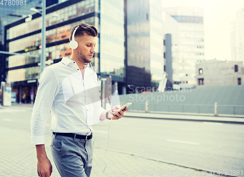 Image of man with headphones and smartphone listening music