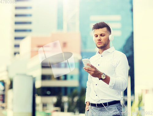 Image of man with headphones and smartphone listening music