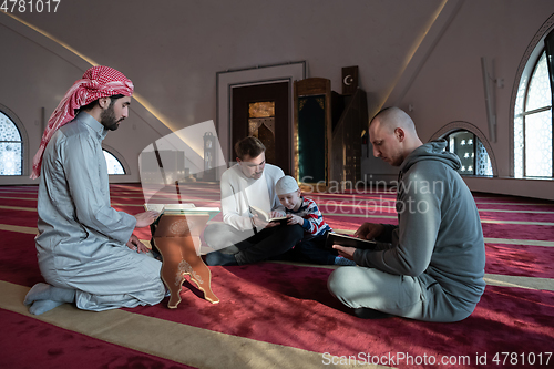 Image of muslim people in mosque reading quran together