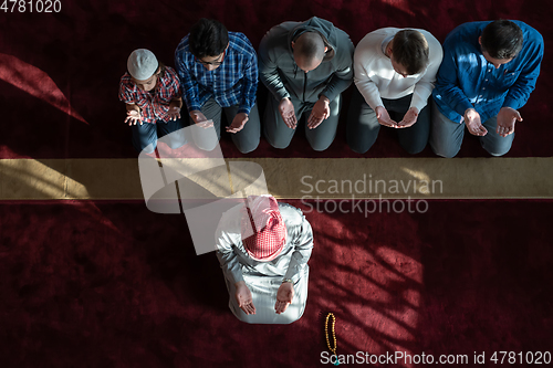 Image of group of muslim people praying namaz in mosque.