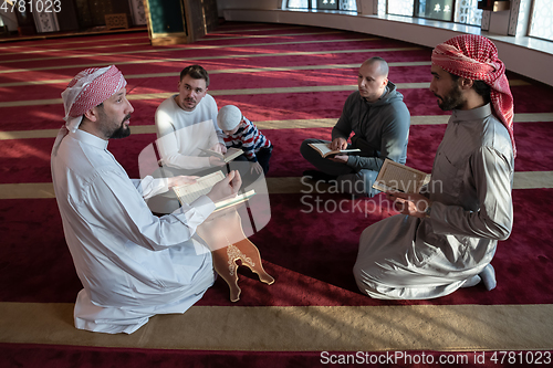 Image of muslim people in mosque reading quran together