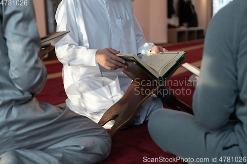 Image of muslim people in mosque reading quran together