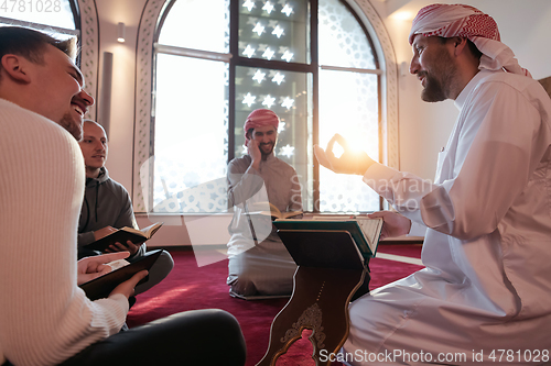 Image of muslim people in mosque reading quran together