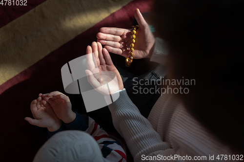 Image of muslim prayer father and son in mosque prayingtogether