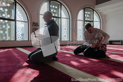 Image of muslim prayer father and son in mosque praying and 