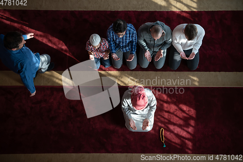 Image of group of muslim people praying namaz in mosque.