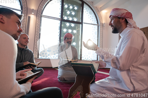 Image of muslim people in mosque reading quran together