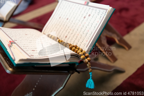 Image of The holy book of the Koran on the stand