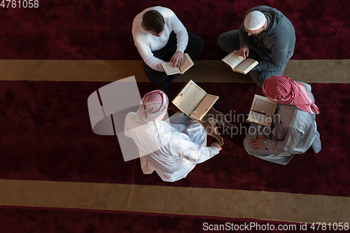 Image of muslim people in mosque reading quran together