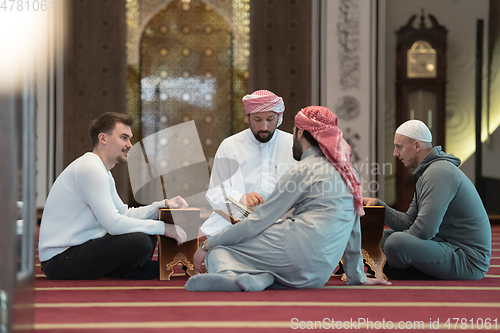 Image of muslim people in mosque reading quran together