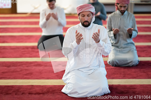 Image of group of muslim people praying namaz in mosque.