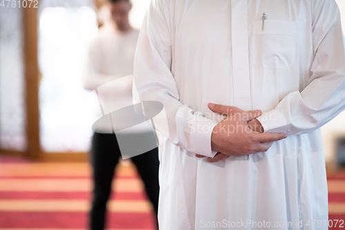 Image of group of muslim people praying namaz in mosque.