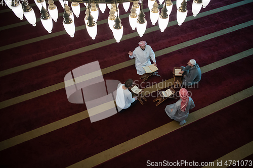 Image of muslim people in mosque reading quran together