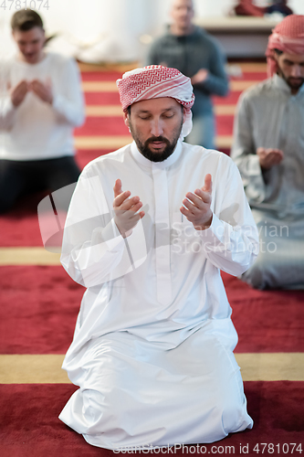 Image of group of muslim people praying namaz in mosque.