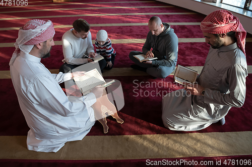 Image of muslim people in mosque reading quran together