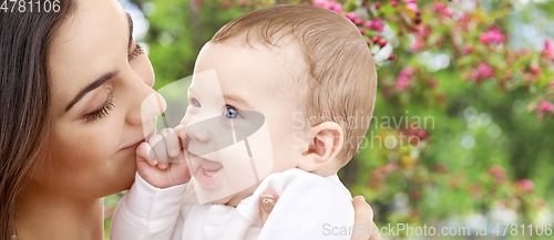 Image of mother with baby over spring garden background