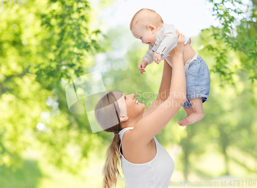 Image of mother with baby over green natural background