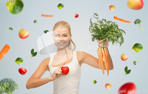 Image of happy smiling young woman with heart and carrots