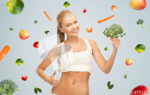 Image of happy smiling young woman with broccoli