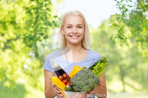Image of smiling young woman with vegetables