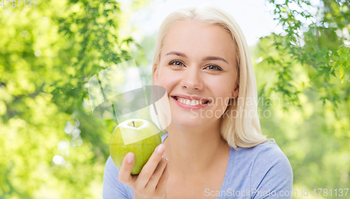 Image of happy woman with green apple