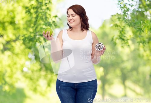 Image of plus size woman choosing between apple and donut