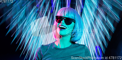 Image of happy woman in pink wig and black sunglasses