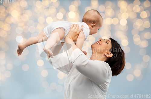 Image of happy middle-aged mother with little baby daughter