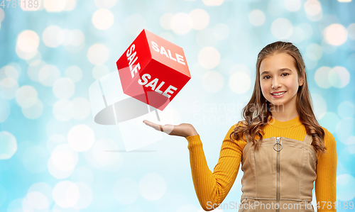 Image of happy teenage girl showing sale sign