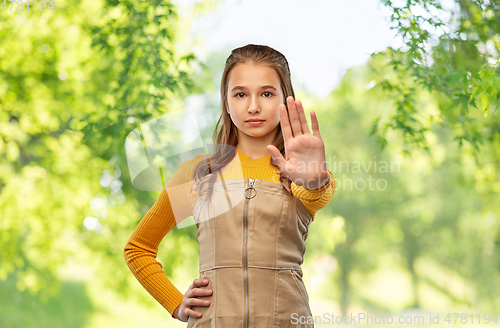 Image of teenage girl making stopping gesture