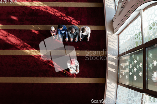 Image of group of muslim people praying namaz in mosque.