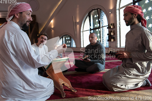 Image of muslim people in mosque reading quran together